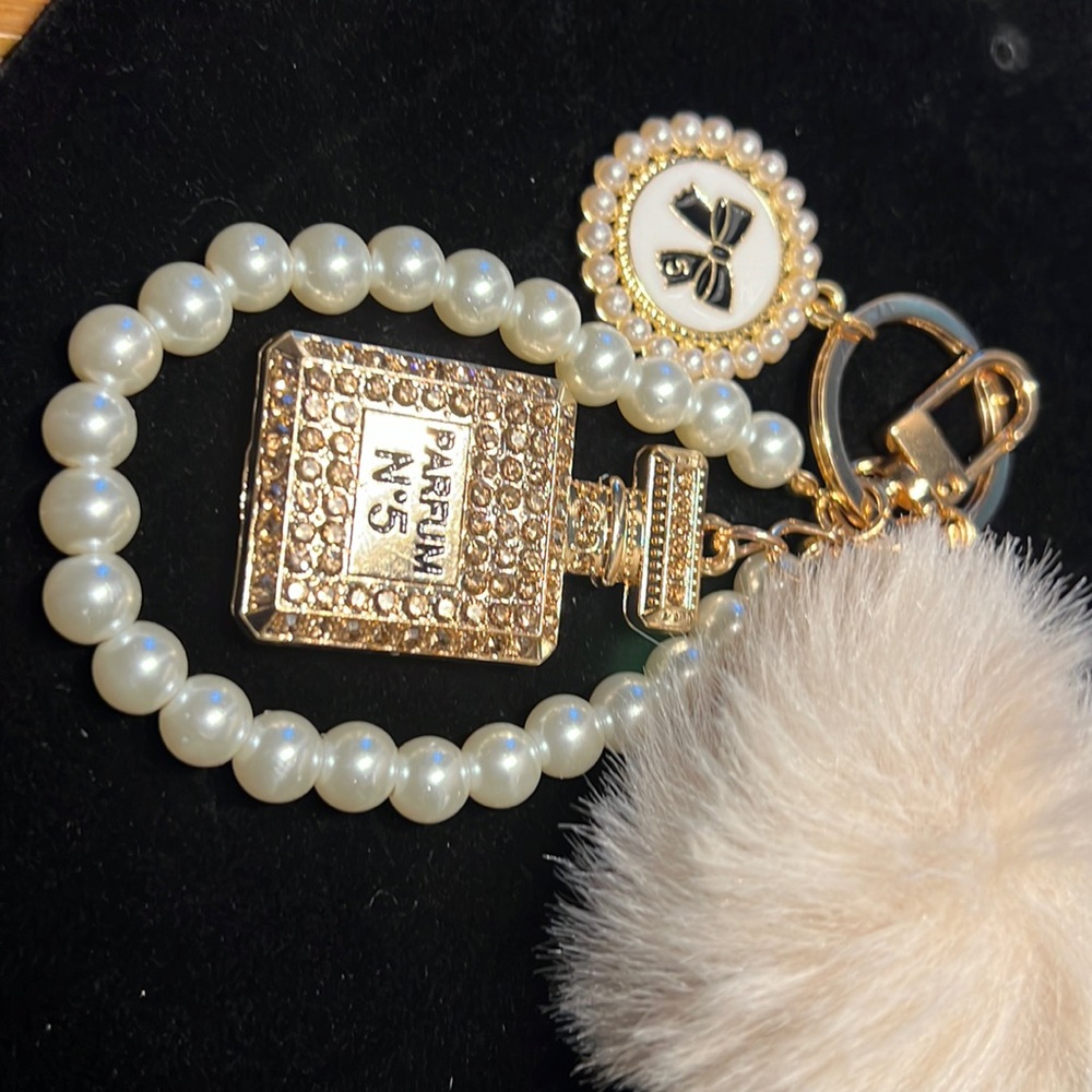 NEW FUN KEYCHAIN FUR BALL WITH PEARLS AND CHARMS.